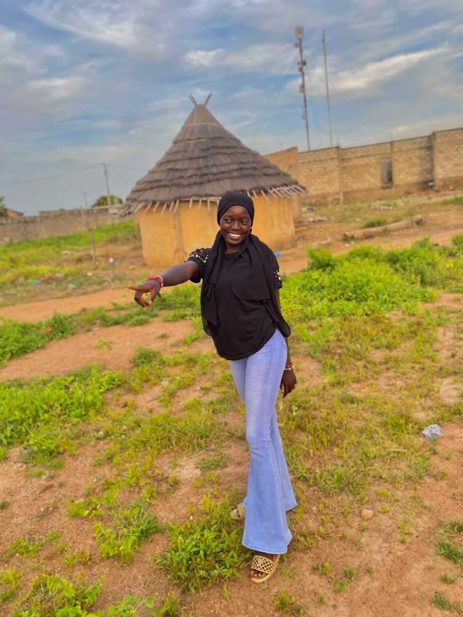 Rima pointing towards her village