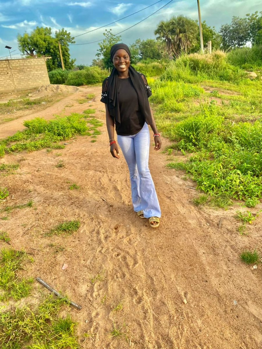 Rima walking along a sandy path